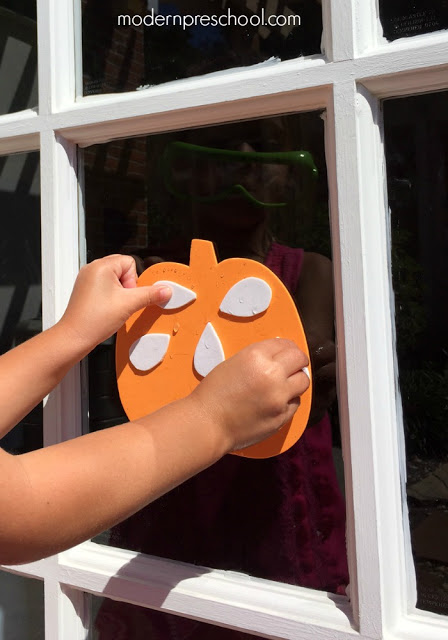 Counting pumpkin seeds with reusable window stickers - perfect activity for toddlers and preschoolers!