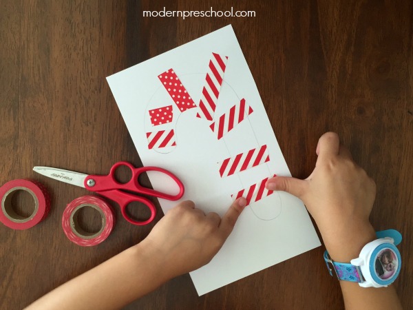 Simple paper candy cane washi tape ornament for kids - decorate and strengthen fine motor skills! 