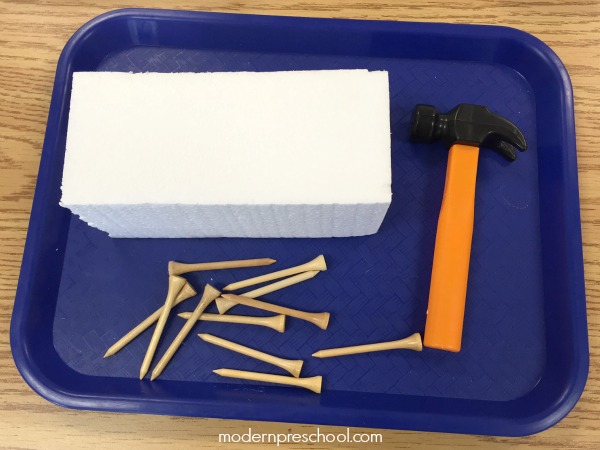 Let's go fine motor ice picking in preschool! Work on fine motor skills and hand-eye coordination with golf tees, hammers, and block of ice.