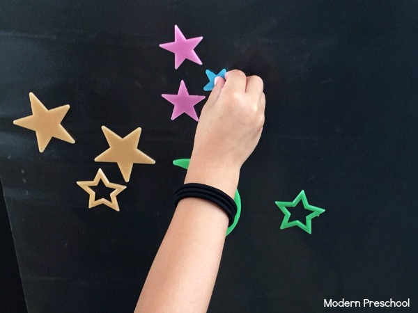 Stars in outer space sticky wall that glows in the dark! Perfect independent play idea for toddlers and preschoolers.