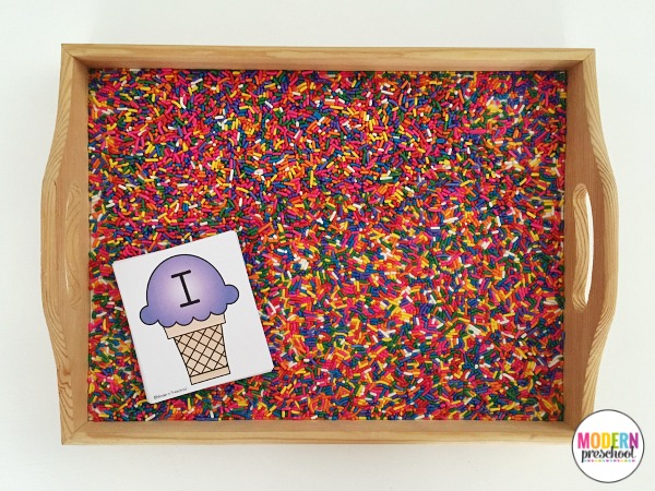 Free printable ice cream and sprinkles alphabet writing practice cards for this super simple sprinkle filled writing tray! Practice pre-writing and fine motor skills. The perfect activity to motivate and engage preschoolers and kindergarteners!